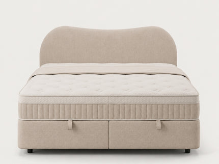 Boxspring Arcus met opbergruimte in beige stof en golvend hoofdbord, vooraanzicht